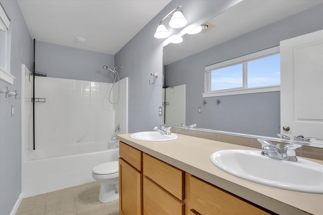 full bathroom featuring toilet, bathing tub / shower combination, a sink, and tile patterned floors