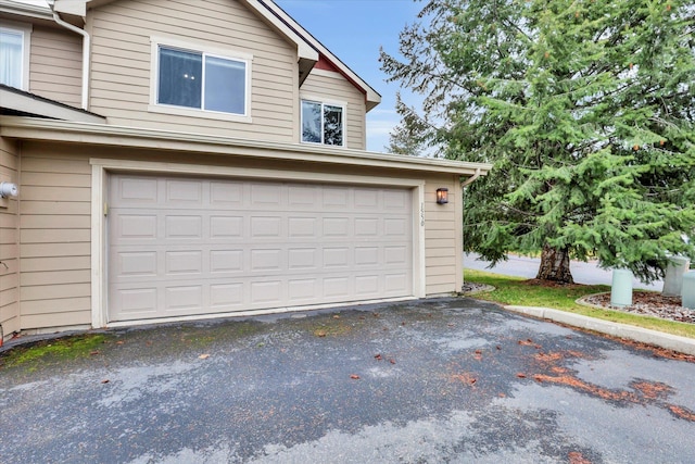 garage with aphalt driveway