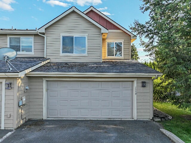 garage featuring aphalt driveway