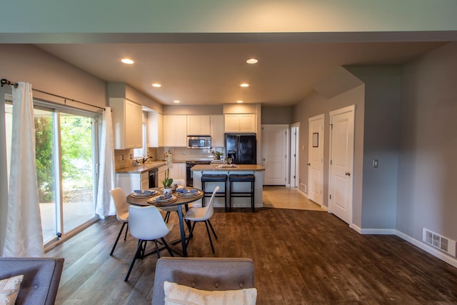 kitchen featuring visible vents, stainless steel microwave, electric range, white cabinetry, and dishwasher