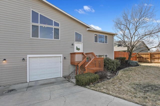 view of front of house with an attached garage and fence