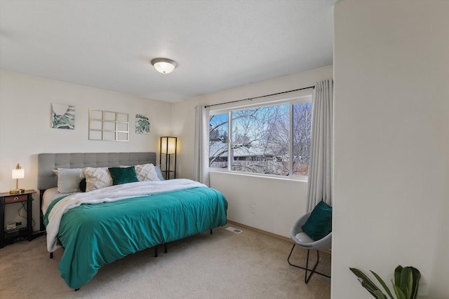 carpeted bedroom featuring baseboards