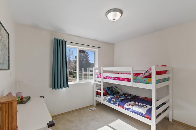 carpeted bedroom featuring visible vents and baseboards