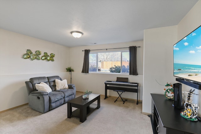 living room featuring baseboards and light colored carpet