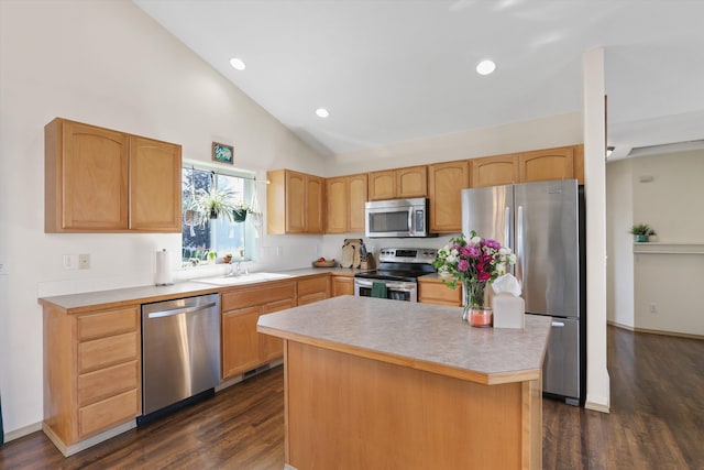 kitchen with stainless steel appliances, light countertops, dark wood-type flooring, vaulted ceiling, and a sink