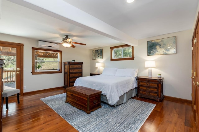 bedroom with beamed ceiling, a wall mounted air conditioner, wood finished floors, and baseboards