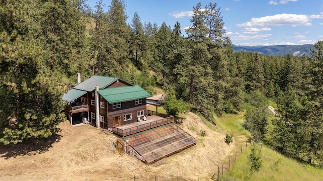 drone / aerial view featuring a wooded view