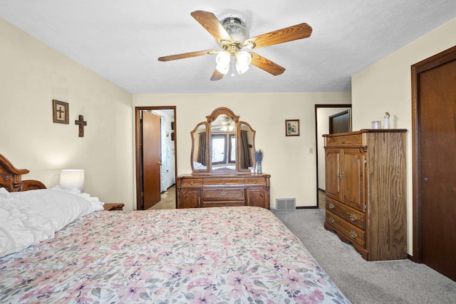 bedroom featuring visible vents, ceiling fan, and carpet flooring