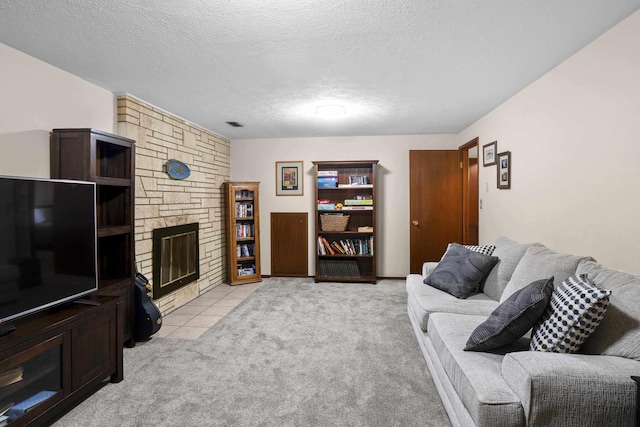 living room with light carpet, a fireplace, and a textured ceiling