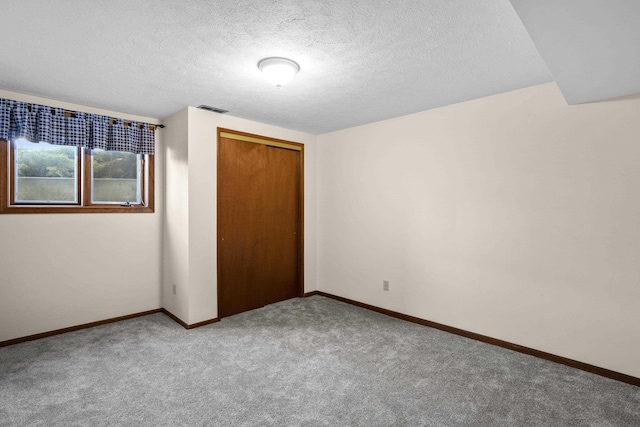 unfurnished bedroom featuring carpet, a closet, visible vents, and baseboards