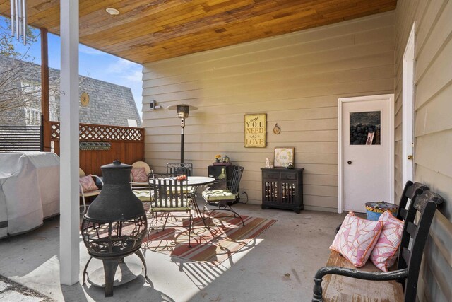 view of patio / terrace with outdoor dining area, fence, and a grill