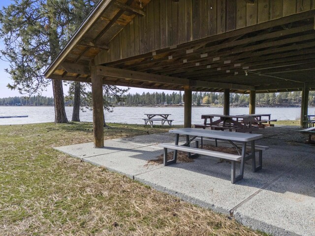 view of home's community featuring a water view and a yard