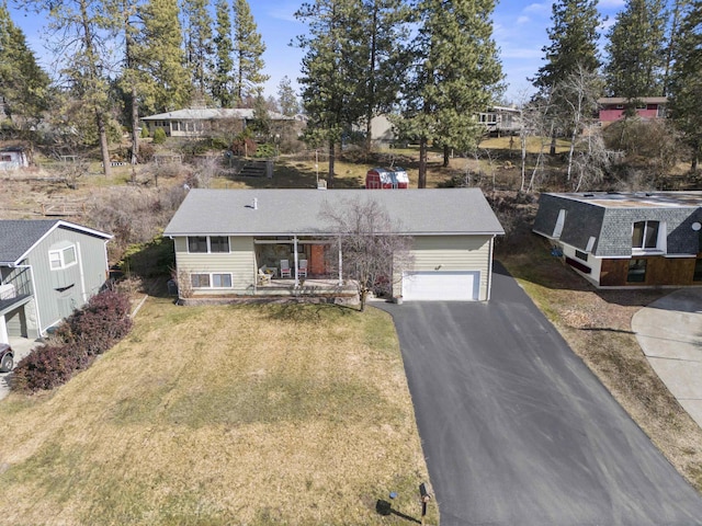 view of front of property with driveway, a garage, and a front yard