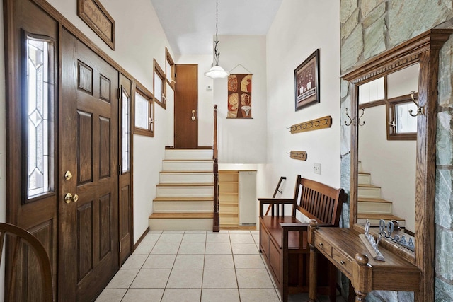 foyer featuring light tile patterned floors and stairs