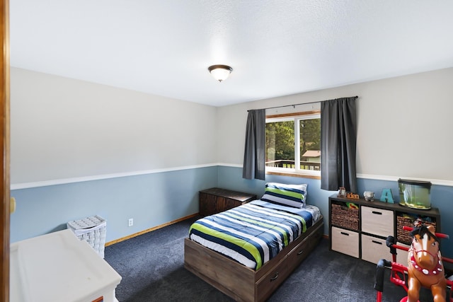 bedroom featuring carpet floors and baseboards