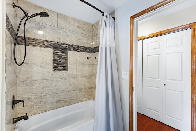 bathroom with shower / tub combo with curtain and wood finished floors