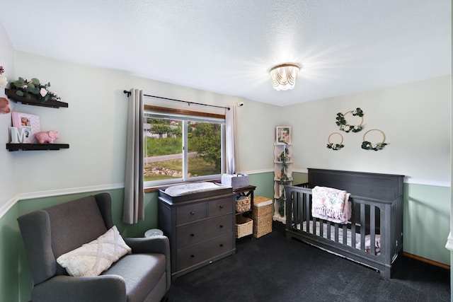 bedroom featuring dark colored carpet and a crib