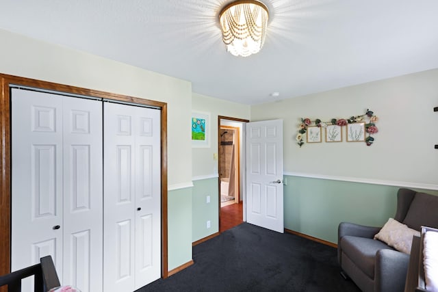 living area with dark colored carpet and baseboards