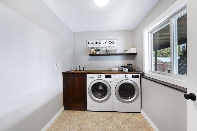 laundry room with cabinet space, baseboards, indoor bar, washer and dryer, and light tile patterned flooring