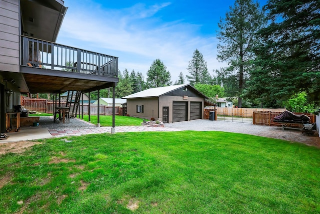 view of yard featuring a fenced backyard, a patio, a detached garage, and an outdoor structure