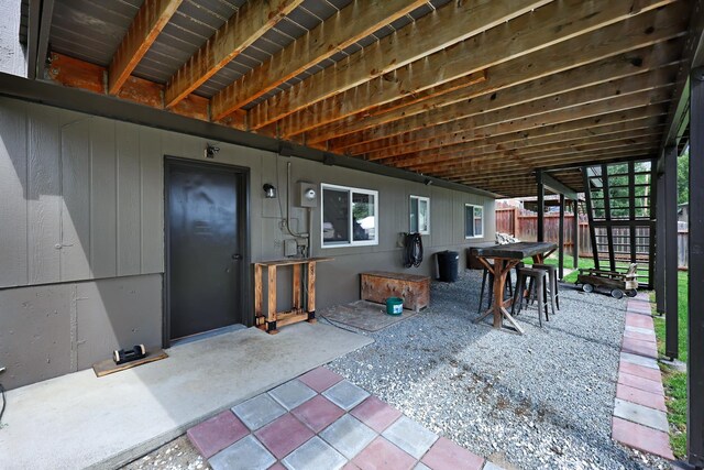 view of patio featuring fence and outdoor dining area