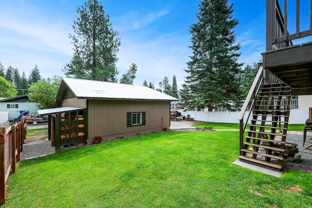 view of yard with fence and stairs