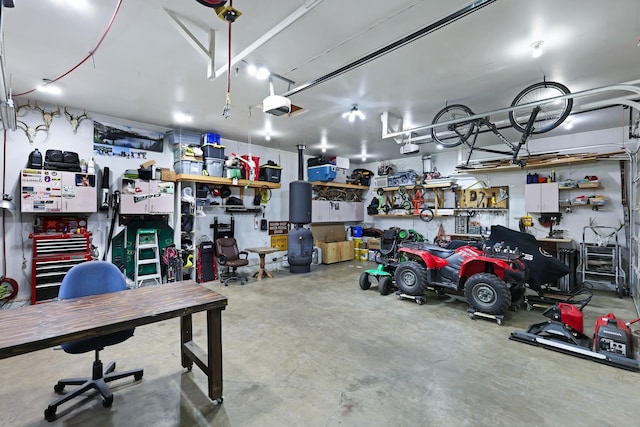 garage with a workshop area and a garage door opener