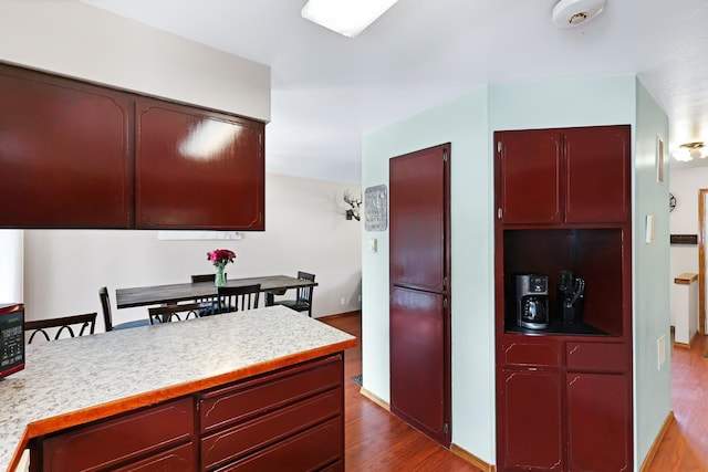 kitchen with light countertops and dark wood-style flooring