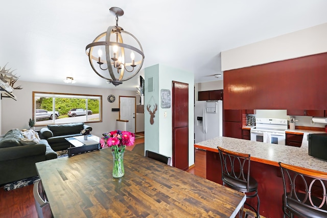 dining area featuring a chandelier and dark wood-type flooring