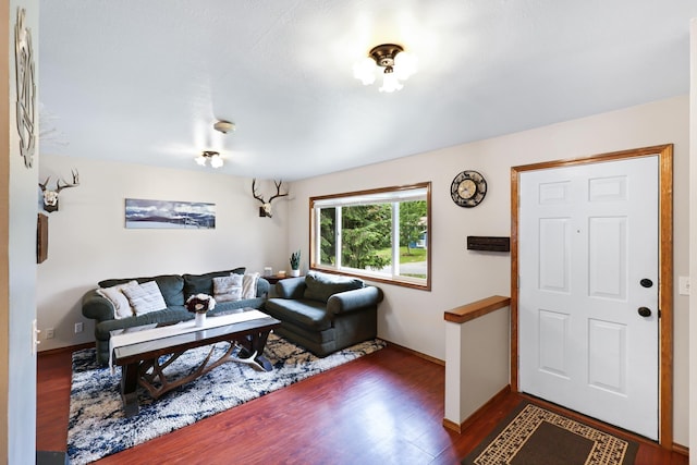 living room featuring baseboards and wood finished floors