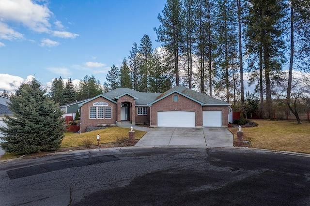 view of front of property with a garage, driveway, a front lawn, and brick siding