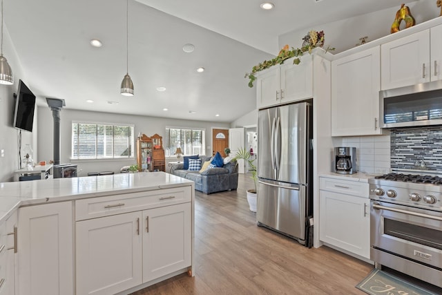 kitchen with light wood-type flooring, appliances with stainless steel finishes, white cabinetry, and light countertops