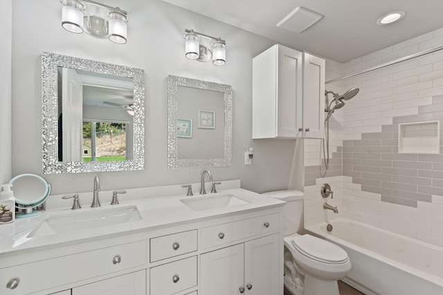 bathroom with  shower combination, toilet, visible vents, and a sink