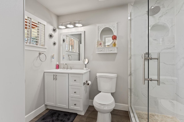 bathroom featuring a marble finish shower, baseboards, and toilet