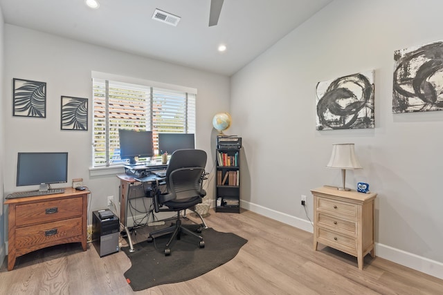 office space featuring visible vents, baseboards, lofted ceiling, and wood finished floors