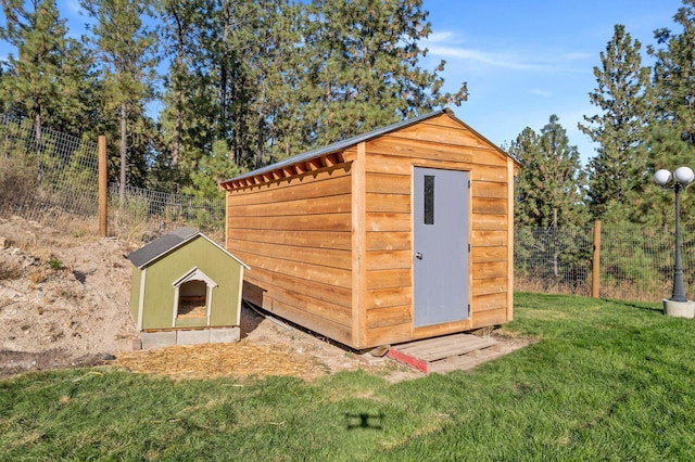 view of shed with fence