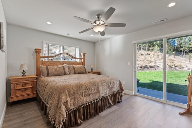 bedroom featuring recessed lighting, visible vents, wood finished floors, and access to outside