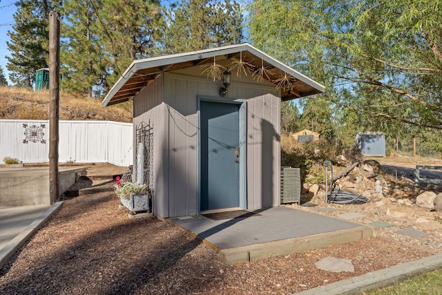 view of shed featuring fence