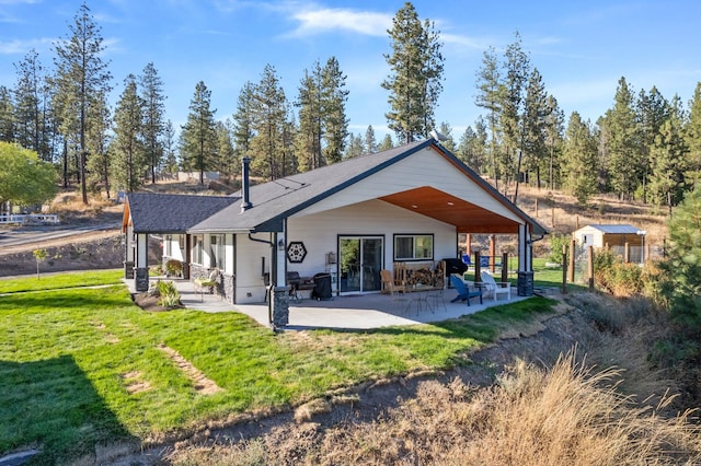 back of property with a patio and a yard