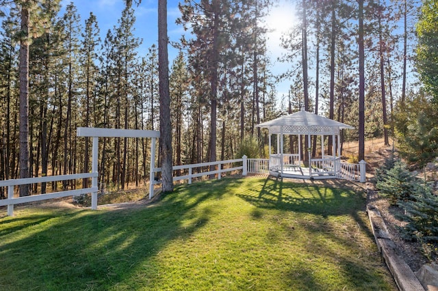 view of yard featuring a gazebo, a deck, and fence