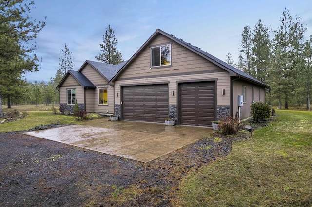 view of front of house with stone siding, concrete driveway, a garage, and a front yard