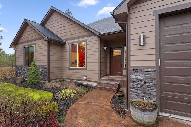 property entrance featuring stone siding and roof with shingles