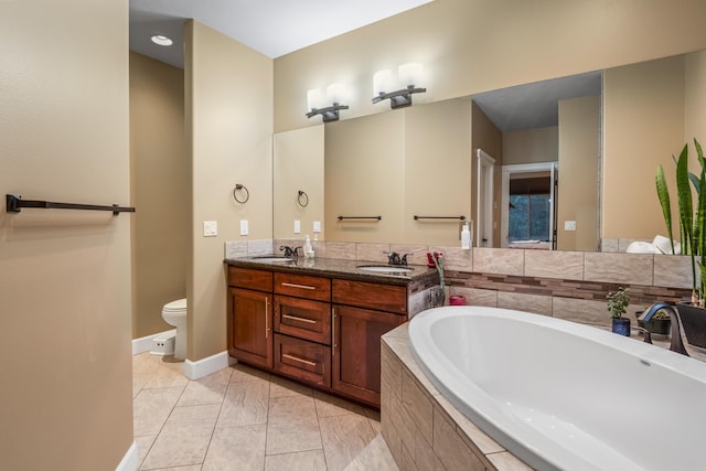 bathroom with a sink, toilet, a bath, and double vanity