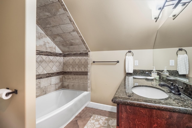 full bathroom with tile patterned floors, lofted ceiling, baseboards, and a sink