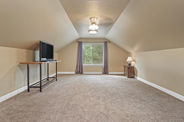 bonus room with lofted ceiling, carpet, baseboards, and visible vents