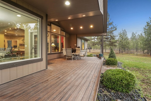 wooden terrace featuring a yard and outdoor dining space