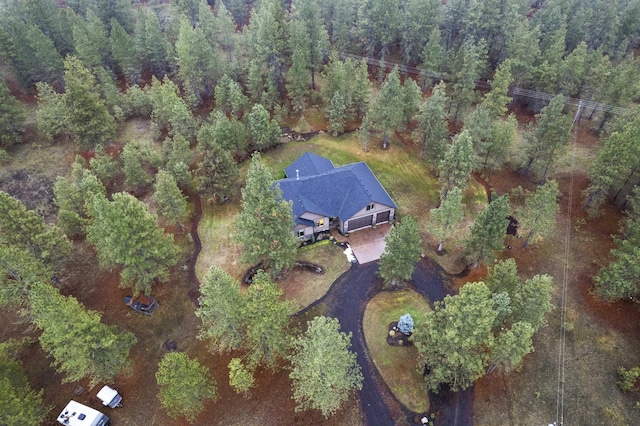 bird's eye view with a wooded view