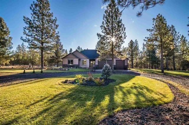 view of front of home with a garage and a front yard