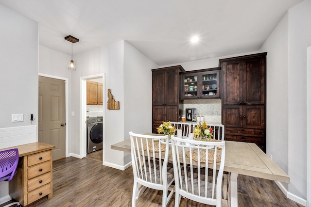 dining space with washer / clothes dryer, dark wood-style floors, and baseboards