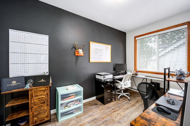 office area with baseboards and wood finished floors